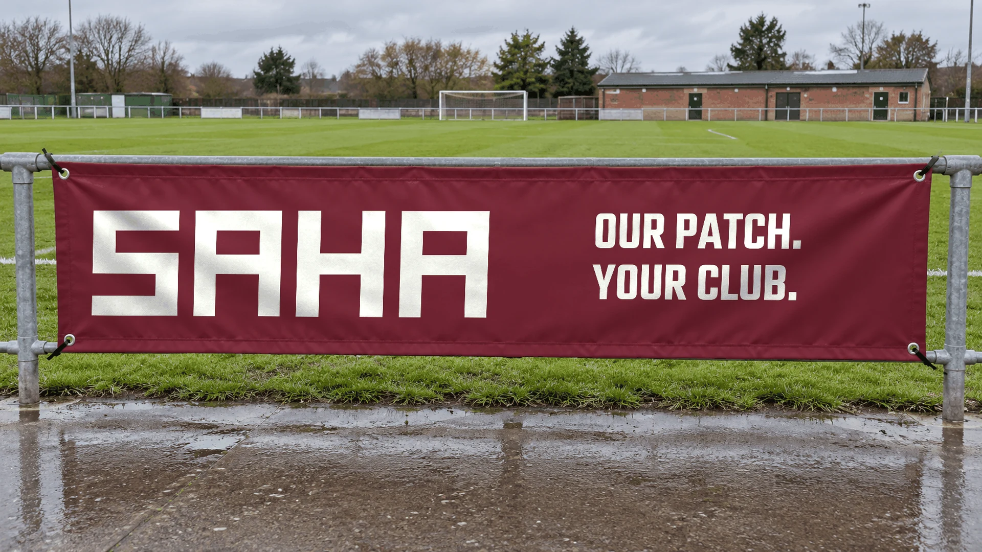 Saha banner attached to the pitchside barrier